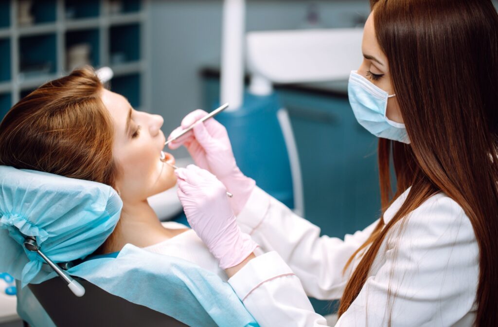 Patient sitting in a dental chair during a routine dental exam.